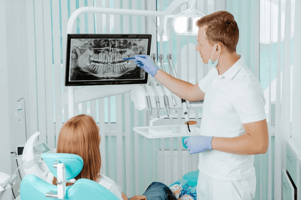 Dentist reviewing a panoramic dental X-ray with a patient