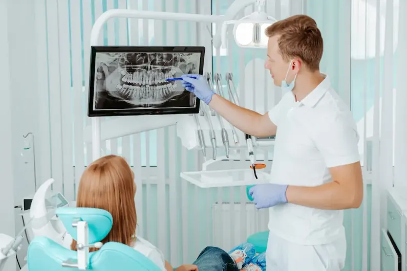 Dentist reviewing a panoramic dental X-ray with a patient