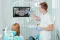 Dentist reviewing a panoramic dental X-ray with a patient